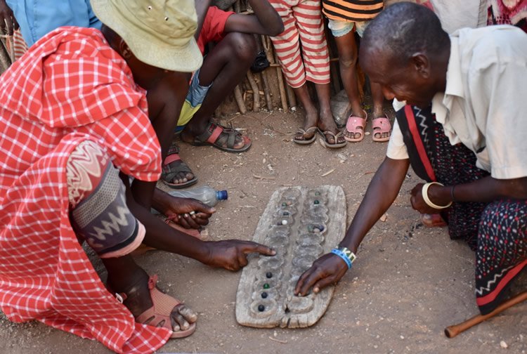 Villagers playing a game called bao.