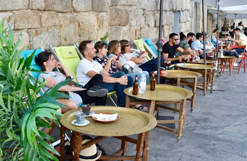 Lounging and people-watching along the river's edge in Porto, Portugal.