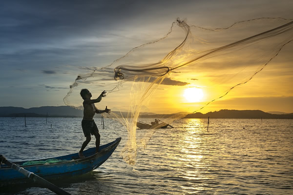 Fishermen at sunset in Vietnam.