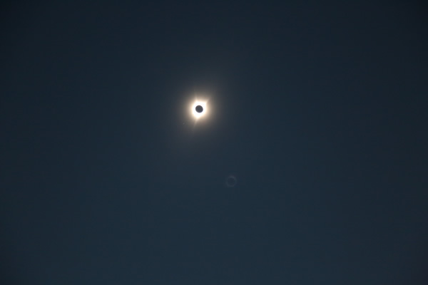 The moon's flaming 'black eye' staring back.