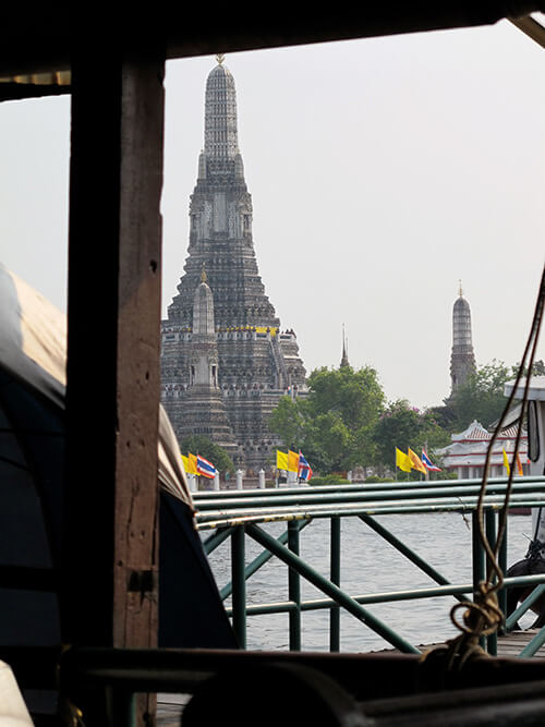 The iconic Wat Arun on Tha Tien Pier near the University of Bangkok, as seen from a boat.