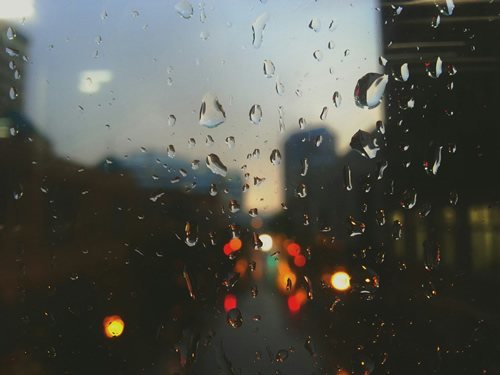 The sound of raindrops as they fall on a window.