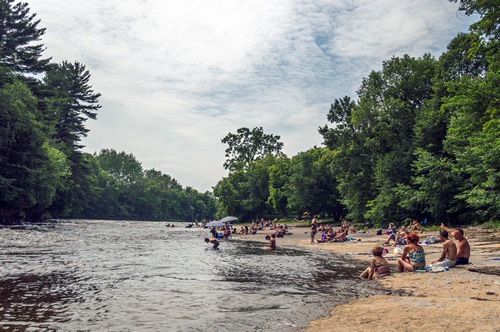 The sounds of the river with a busy beach in a tropical country.