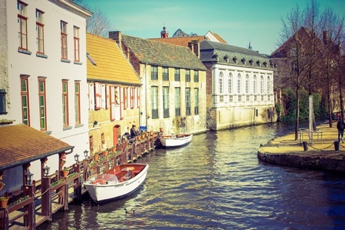 Peaceful river scene in a European town.