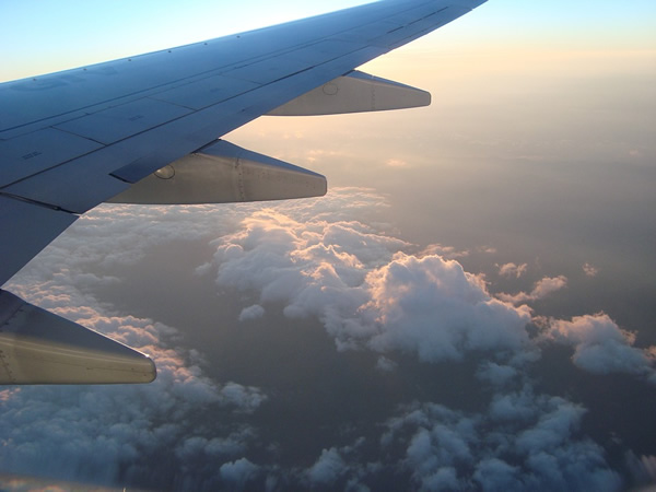 A view out of the window seat of a plane looking through the clouds over the Brazilian Amazon.