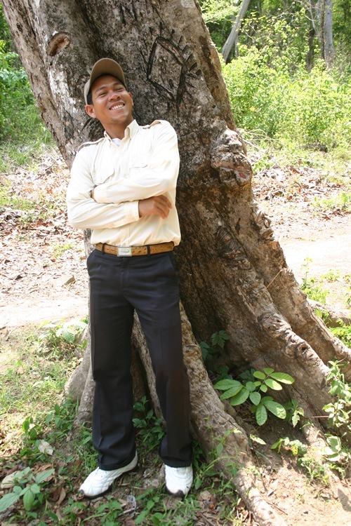 My guide, Sokhoue, standing on tank mine spo in Cambodia.