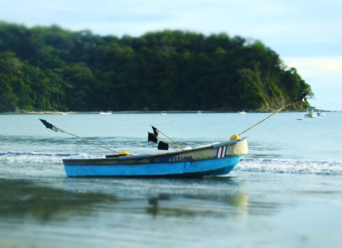 A small empty fishing boat in the peaceful ocean in Samara.