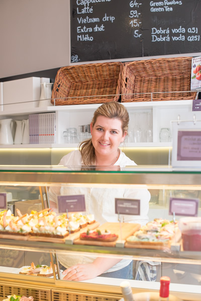 Chlebíčka snacks served by a woman in a bakery in Prague.