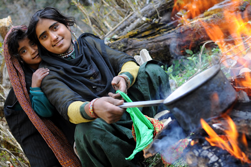 Van Gujjar women cooking for the Van Gujjar tribe in India.