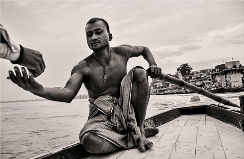Boatman at dawn on Ganges River in India.