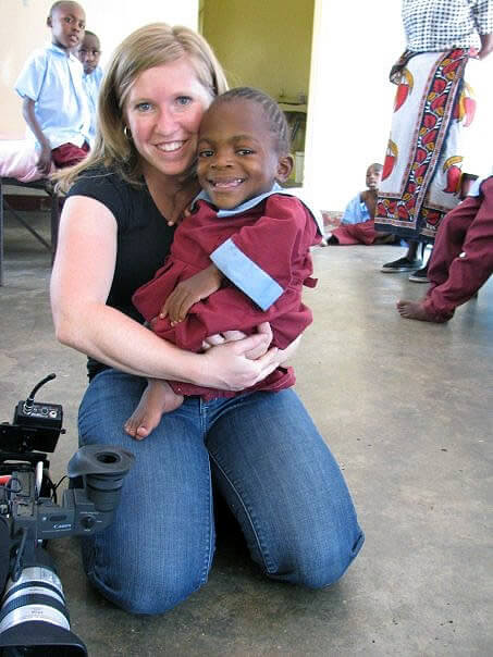 Holding a child in Kenya while doing a documentary.