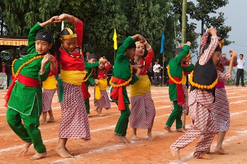 Children dancing in their school outfits in the Himalayan town.