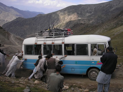 Pushing the bus stuck in a mountain road in Pakistan.