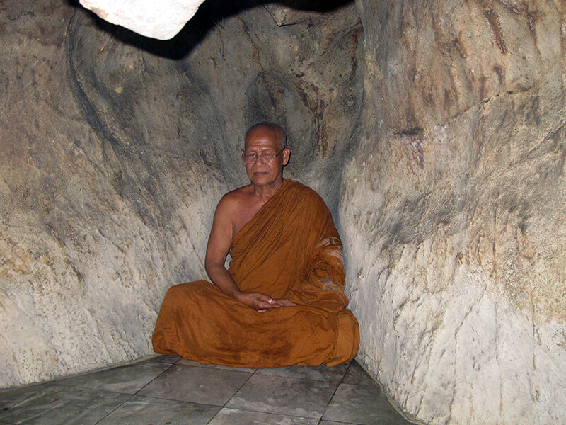 Monk in a cave in Thailand.