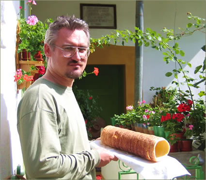 ElderTreks guide, Lajos Nemeth in Transylvania serving the group a fresh chimney cake.