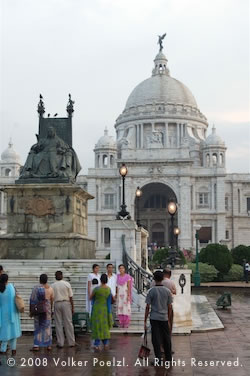 Kolkata, India with people in rain on square.