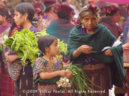 Woman and children in the market in local clothing makes for an interesting photo subject.