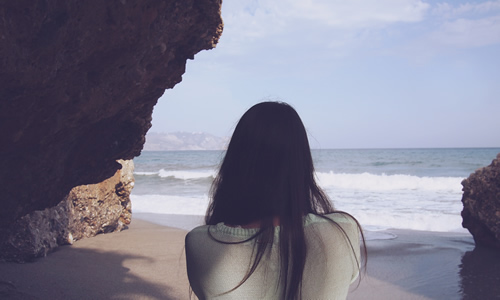 Solo woman traveler on beach.