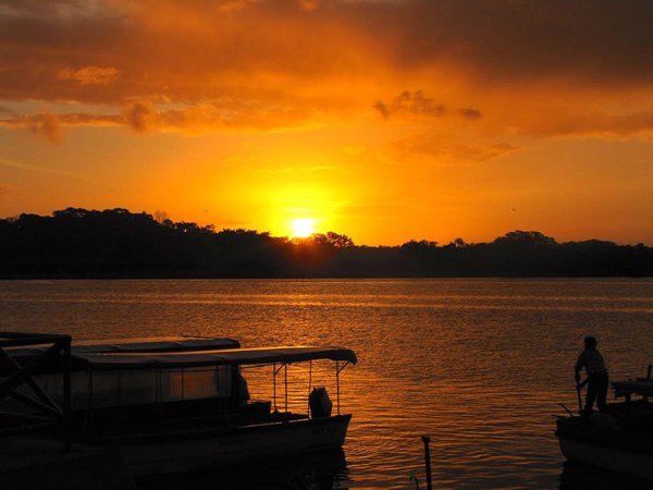 Farm work: sunrise seen from boats on a river.