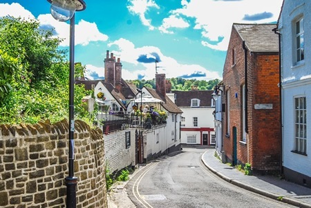 Traveling along road with townhouses in England.