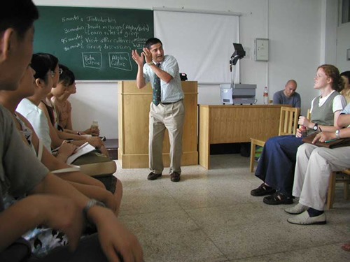 The author teaching English abroad to students in a classroom.