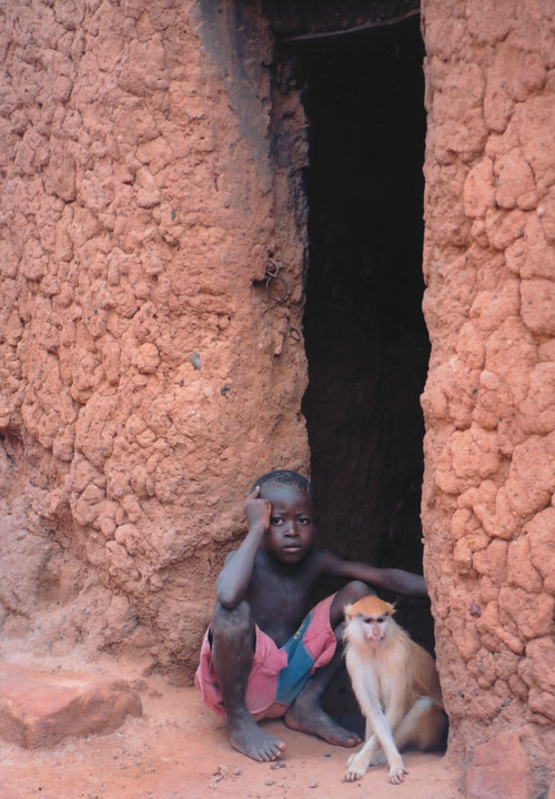 A child in Burkino Faso sitting pensively in a Peace Corps volunteer's village.