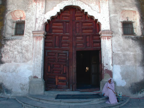 Portrait photograph of woman in front of church in Mexico.