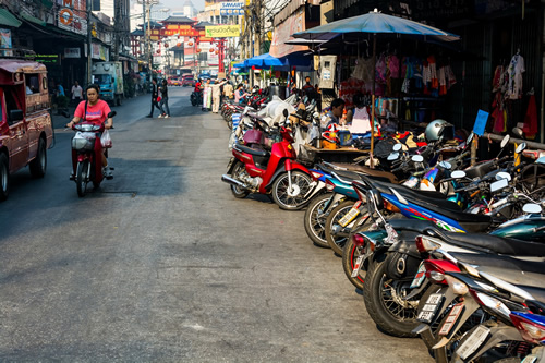 Market with motorbikes parked in front in Chiang Mai.