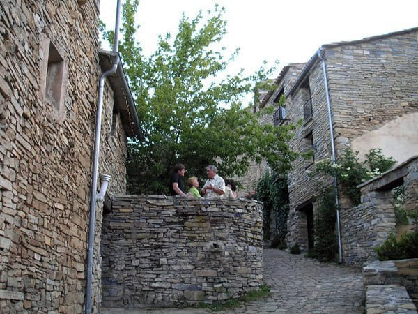 Volunteer in cobblestoned village of a village in Spain.