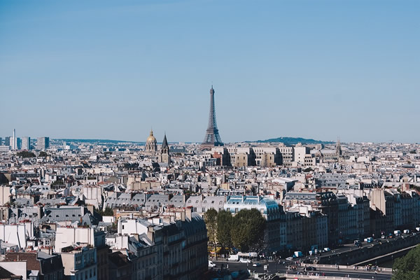 Apartment buildings and monuments seen in the skyline of Paris.