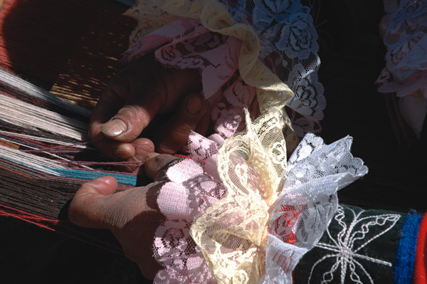 The hands of a weaver in action.