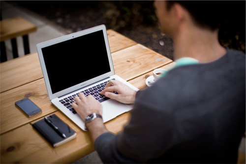 Using a laptop to write an international resume.