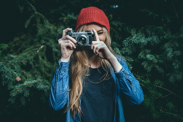 Woman traveling and studying solo taking a photo.