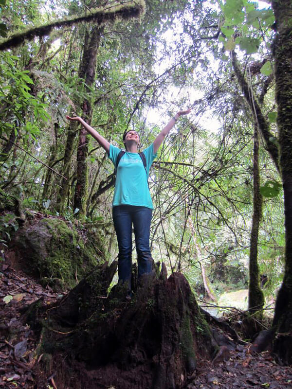 The author exploring and embrassing biodiversity, arms raised, in a Nicaraguan forest.